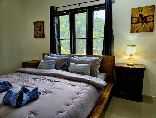 a bedroom with a large bed with a window at Suwaree Garden in Koh Samui
