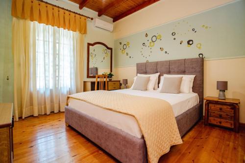 a bedroom with a large bed and a window at Eleas Gi Villa in Vitalades