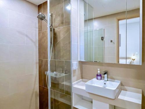 a bathroom with a sink and a shower at The Song Boutique Apartment in Vung Tau