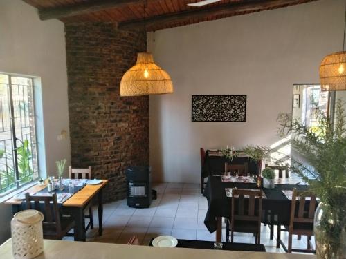 a dining room with a table and chairs at Nylstroom Guesthouse in Modimolle