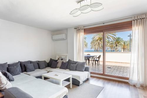 a living room with a couch and a view of the ocean at Marenostrum Villa in Valencia