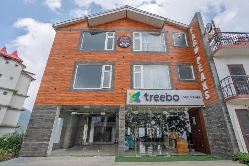 a red brick building with a treeloo sign on it at Treebo Fagu Peaks in Shimla