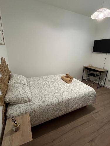 a bedroom with a bed with a teddy bear on it at Chambre privée in Vénissieux