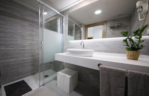 a bathroom with a sink and a shower at Hostal Cervantes Playa in Garrucha