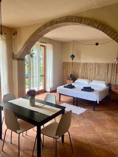 a bedroom with a bed and a table and chairs at Nùi Homestay in Monastero di Lanzo