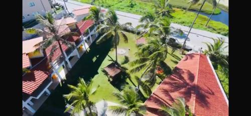 an aerial view of a building with palm trees at Pousada Água Azul in Flecheiras