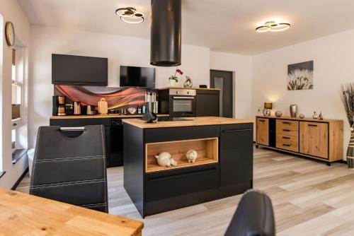a kitchen with an island with a stove top oven at Ferienwohnung Hopf in Bad Liebenstein