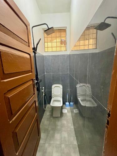 a bathroom with a toilet and a sink at Hello Rafiki Stone town in Zanzibar City