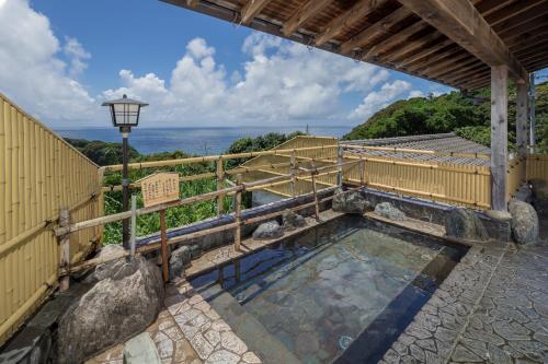 a pool of water with a fence and a street light at Ashizuri Kokusai Hotel in Tosashimizu