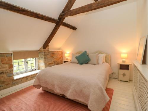 a bedroom with a large bed in a attic at The Farmhouse in Langport