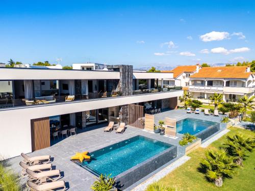 an aerial view of a house with a swimming pool at Villa Sika in Vir