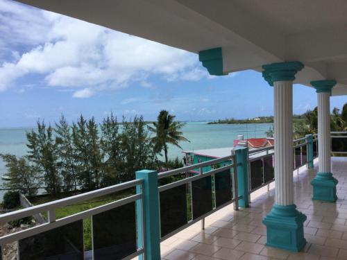 a balcony with a view of the ocean at Orient Guesthouse Auberge in Mahébourg
