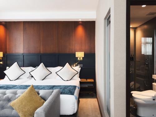 a hotel room with a bed and a couch at Moon Hotel in George Town