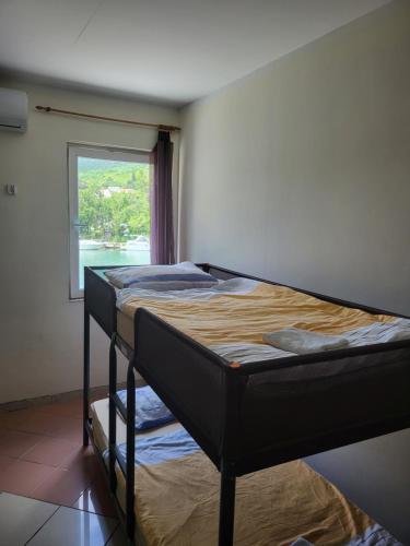 a bunk bed in a room with a window at Hostel Dubrovnik Center Free Parking in Dubrovnik
