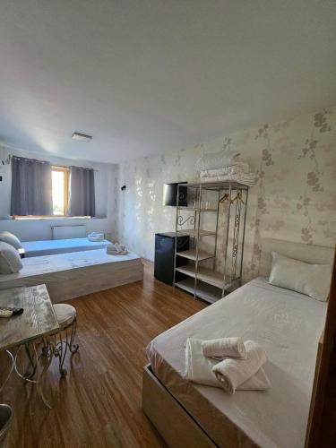 a large room with two beds and a couch at Family Hotel Amor in Ruse