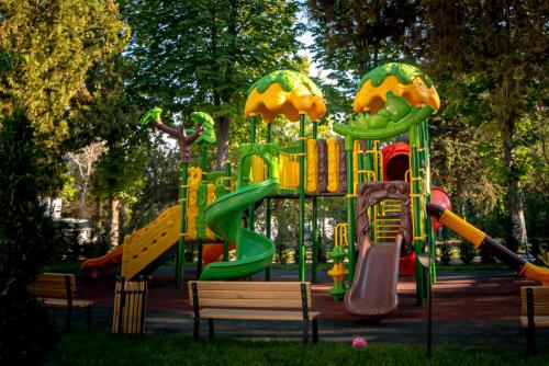 a playground with a slide in a park at Hotel Corina in Venus