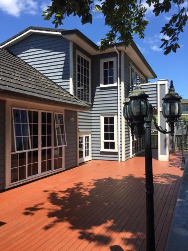 a house with a light pole in front of it at The Gardens Bed and Breakfast in Auckland