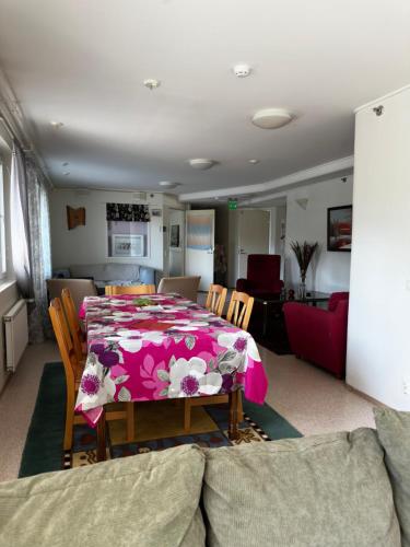 a dining room with a table and a living room at Himangan majatalo in Kalajoki