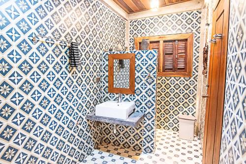 a bathroom with a sink and a mirror at Mlis Kampot River in Kampot