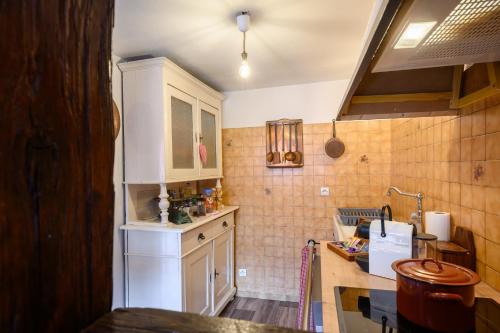 a kitchen with white cabinets and a counter top at voyage en Alsace chez Gaby in Hunawihr