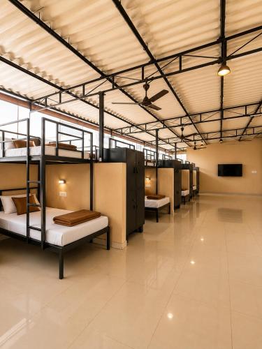 a group of bunk beds in a large room at SLV Comforts in Chikmagalūr