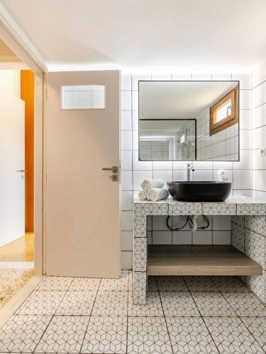 a bathroom with a sink and a mirror at 4BR Newly Renovated Retreat Tranquil Coastal Haven in Hersonissos