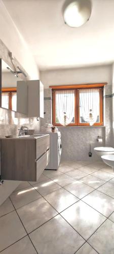 a white kitchen with a sink and a counter at Casa Vela in Riva del Garda