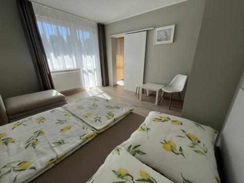 a bedroom with two beds and a chair in it at Rafa in Rowy