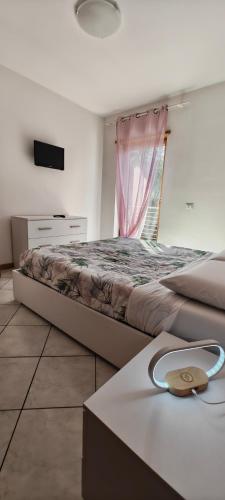 a bedroom with a large bed and a table at Casa Vela in Riva del Garda
