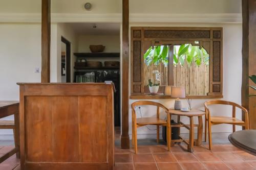 a dining room with a table and chairs at Sunset Loft Seminyak, Bali in Seminyak