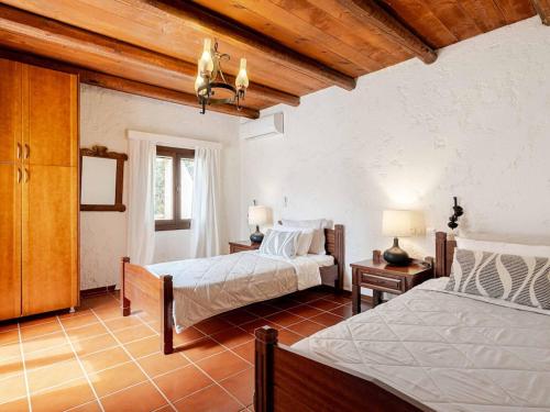 a bedroom with two beds in a room at Stalis Bay Villa in Stalís
