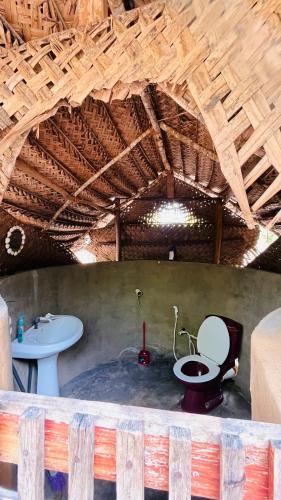 a bathroom with a toilet and a sink at Nilana beach cabana in Panama