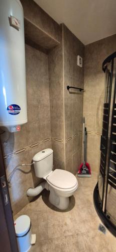 a bathroom with a white toilet in a room at MitProt Panorama Bay 2 Luks Studio 170 in Sveti Vlas