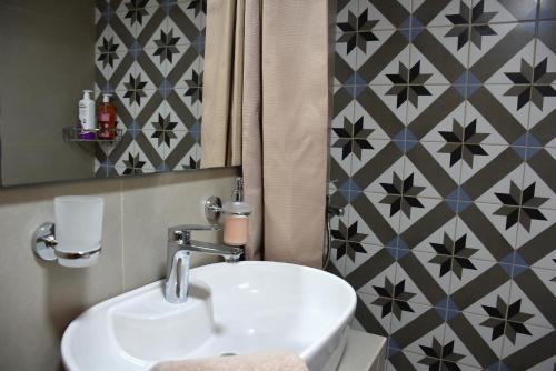 a bathroom with a sink and a mirror at Avli in Samothraki