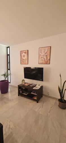 a living room with a television and a table at Piso Tamaragua in Arrecife