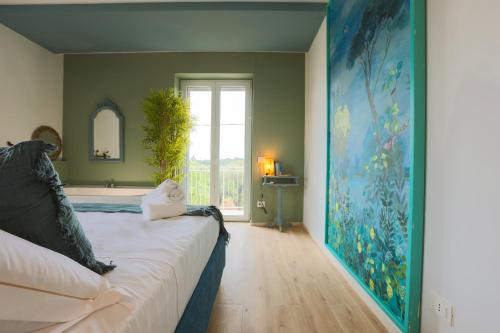 a bedroom with a bed and a large painting on the wall at Dimore Tinè in Castellana Grotte