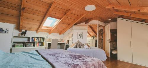 a bedroom with two beds and a wooden ceiling at Istria Stone House in Marasi