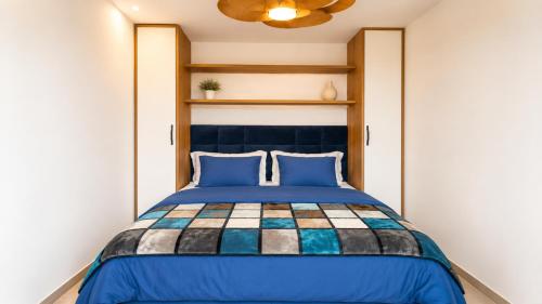 a bedroom with a blue bed with blue pillows at Casita del Toro - Rooftop Terrace & Sea View in Vinarós