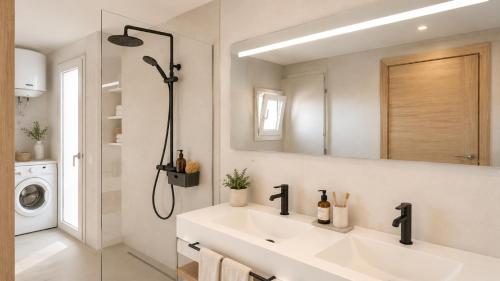 a bathroom with a sink and a washing machine at Casita del Toro - Rooftop Terrace & Sea View in Vinarós