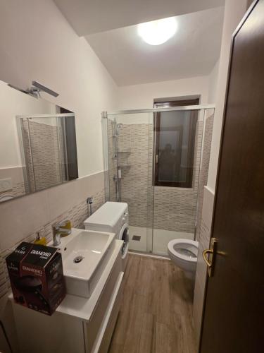 a bathroom with a sink and a toilet at La Tana - Borno Holiday in Borno