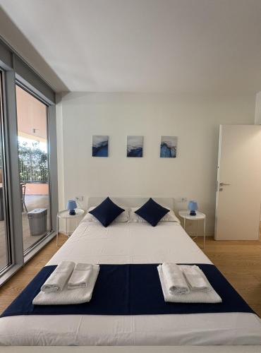 a bedroom with a large bed with two pillows at Waterfront Porto Antico House in Genoa