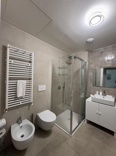 a bathroom with a toilet and a shower and a sink at Waterfront Porto Antico House in Genoa