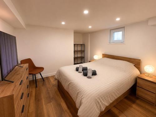 a bedroom with a bed and a desk and a chair at Piscine et pétanque - Calme proche Belfort in Châlonvillars