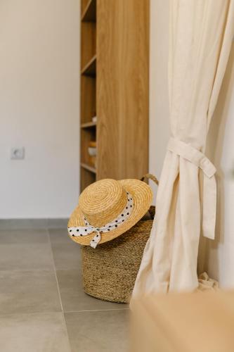 a straw hat sitting on top of a basket at Seafront Villa in Kornati Private Terrace and Direct Beach Access in Kornati