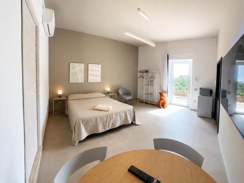 a bedroom with a bed and a table at MP Luxury room in Budoni