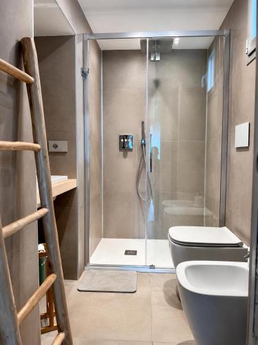 a bathroom with a shower with a toilet in it at MP Luxury room in Budoni