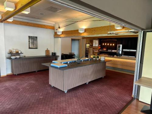 a large room with a kitchen and a counter at Overhalla Hotel in Overhalla 