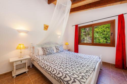 a bedroom with a bed and a window at Apartment Tina Capdepera in Capdepera