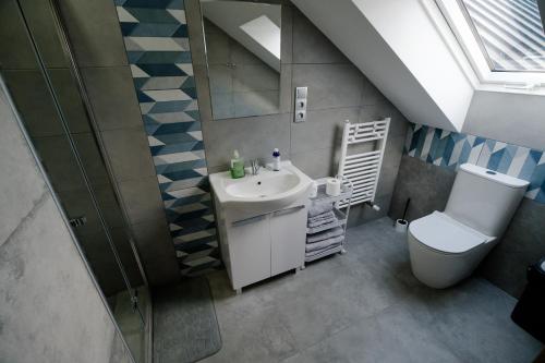a bathroom with a sink and a toilet at VISTA Necko - apartament nad jeziorem Augustów in Augustów