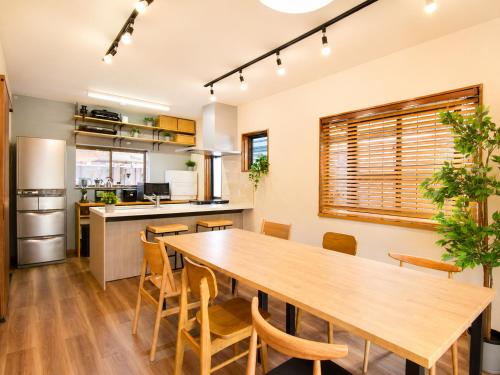 a kitchen and dining room with a wooden table and chairs at にし阿波ねすと in Higashimiyoshi